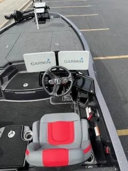 Slide: The Image of 2024 iKon LX 21 boat interior with Garmin navigation displays and red-gray seating. - 7