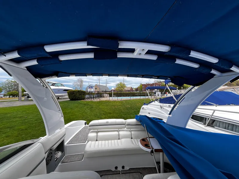 Slide: The Image of 2016 Cobalt R30 boat interior with blue canopy and white seating. - 10