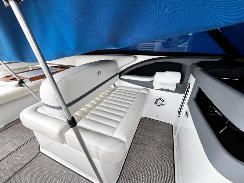 Slide: The Image of Luxurious interior of a 2016 Cobalt R30 boat with white seating and blue canopy. - 12