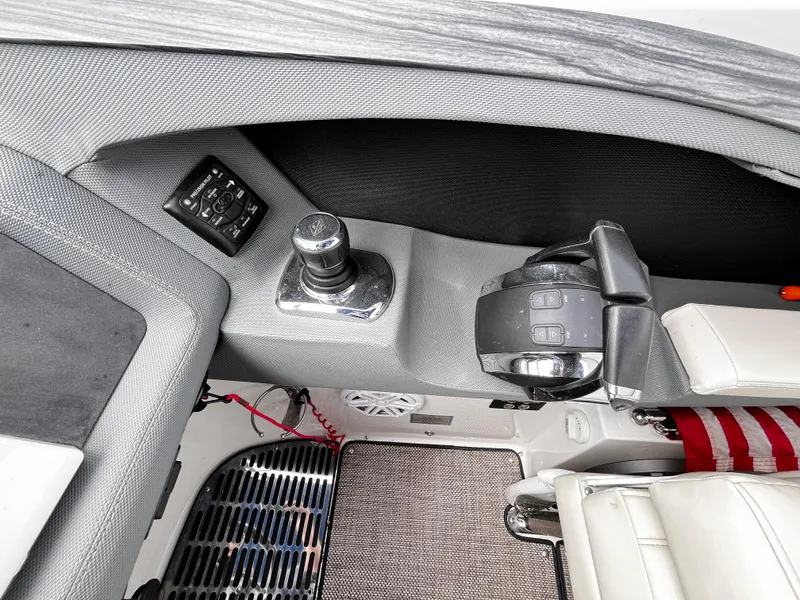 Slide: The Image of Interior of a 2016 Cobalt R30 boat, featuring controls and seating area. - 13
