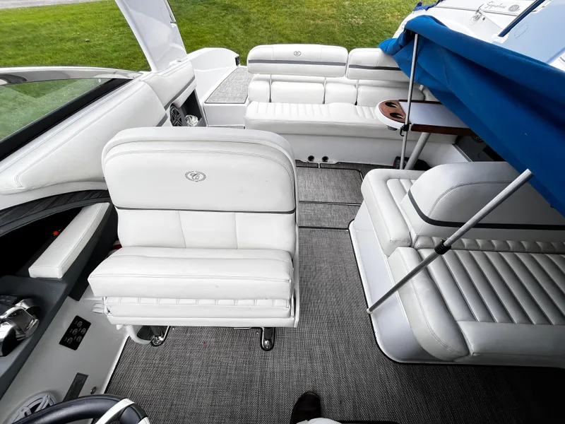 Slide: The Image of 2016 Cobalt R30 boat interior with white leather seating and blue canopy. - 16