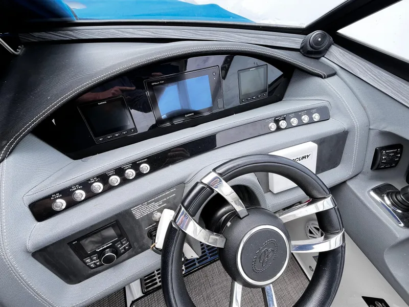 Slide: The Image of 2016 Cobalt R30 boat dashboard with steering wheel and control panels. - 18