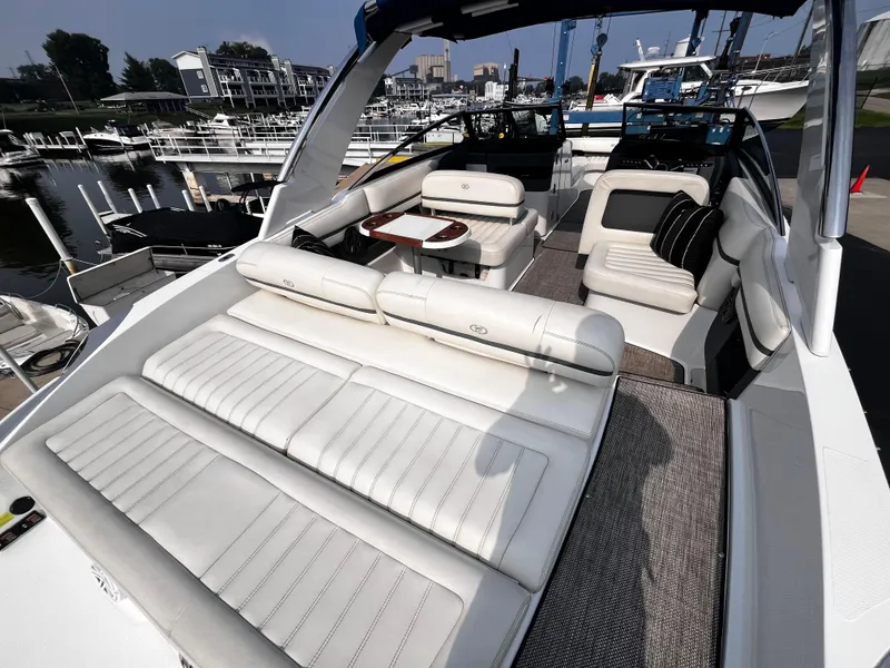 Slide: The Image of Luxurious 2016 Cobalt R30 boat interior with white seating, docked at a marina. - 30