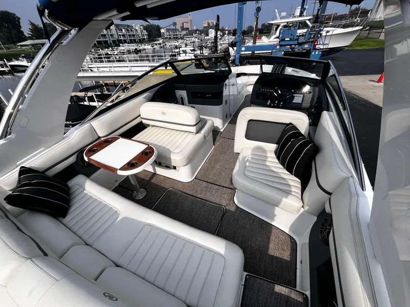 Slide: The Image of Luxurious 2016 Cobalt R30 boat interior with white seating and a wooden table. - 33