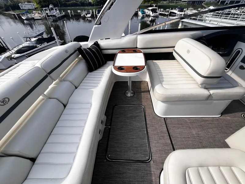 Slide: The Image of Luxurious 2016 Cobalt R30 boat interior with white leather seating and wooden table. - 34