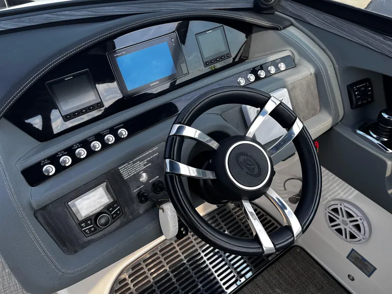 Slide: The Image of Dashboard of a 2016 Cobalt R30 boat with steering wheel and electronic displays. - 39