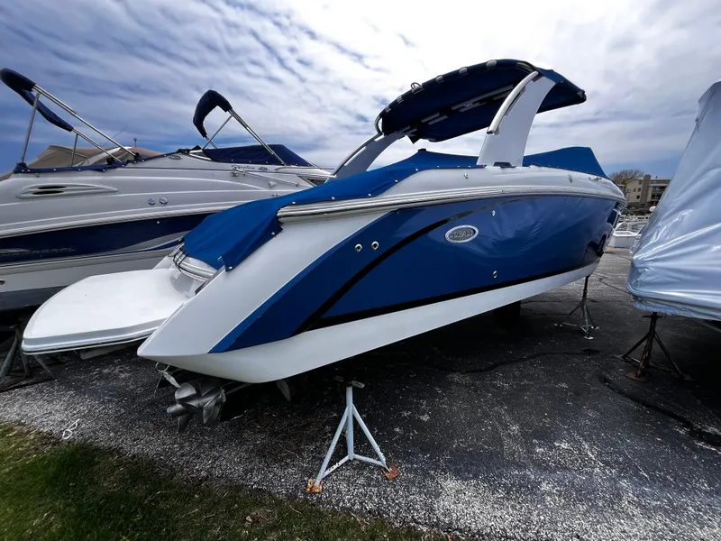 Slide: The Image of 2016 Cobalt R30 boat in blue, parked on a stand under a cloudy sky. - 4