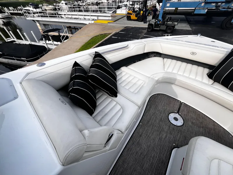 Slide: The Image of Luxurious 2016 Cobalt R30 boat interior with white seating and striped cushions at a marina. - 43