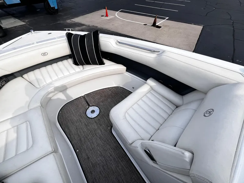 Slide: The Image of 2016 Cobalt R30 boat interior with white leather seating and black-striped pillow. - 44