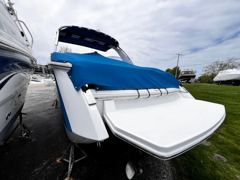 Slide: The Image of 2016 Cobalt R30 boat with blue cover, parked outdoors on a cloudy day. - 5