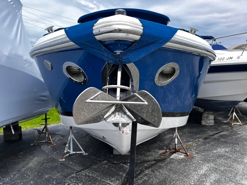 Slide: The Image of 2016 Cobalt R30 boat with blue hull, anchored on stands, front view. - 6