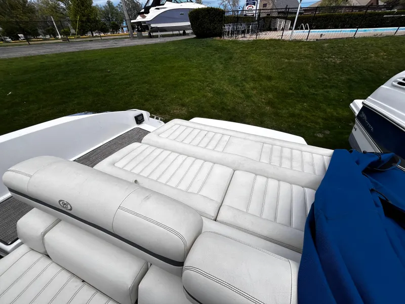 Slide: The Image of 2016 Cobalt R30 boat with white leather seating, parked on grass near a pool. - 7