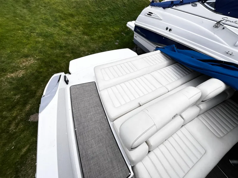 Slide: The Image of 2016 Cobalt R30 boat with white leather seating and blue cover on grass. - 9