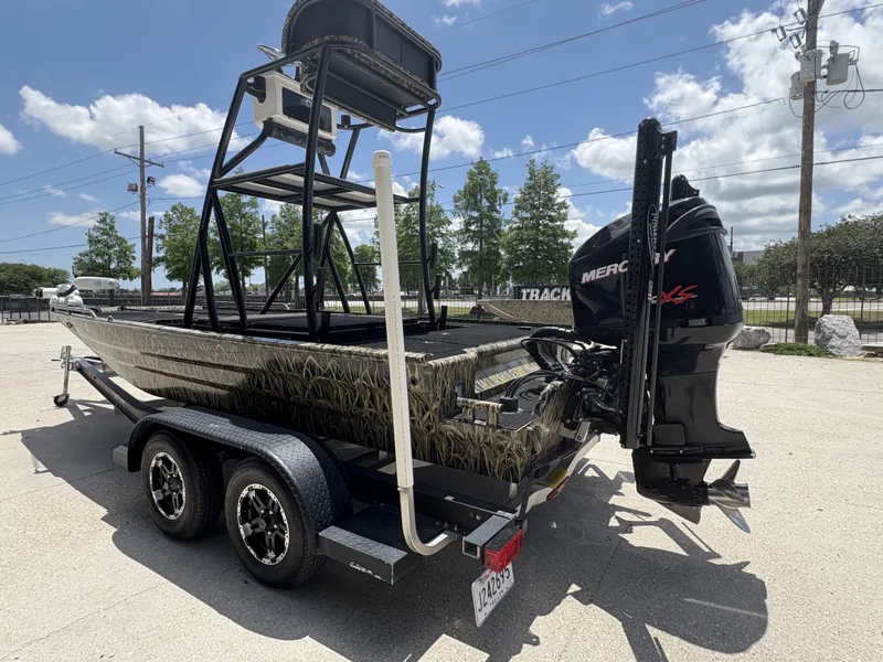 Slide: The Image of 2017 Prodigy 20 x 72 boat with Mercury engine on trailer, parked outdoors. - 4