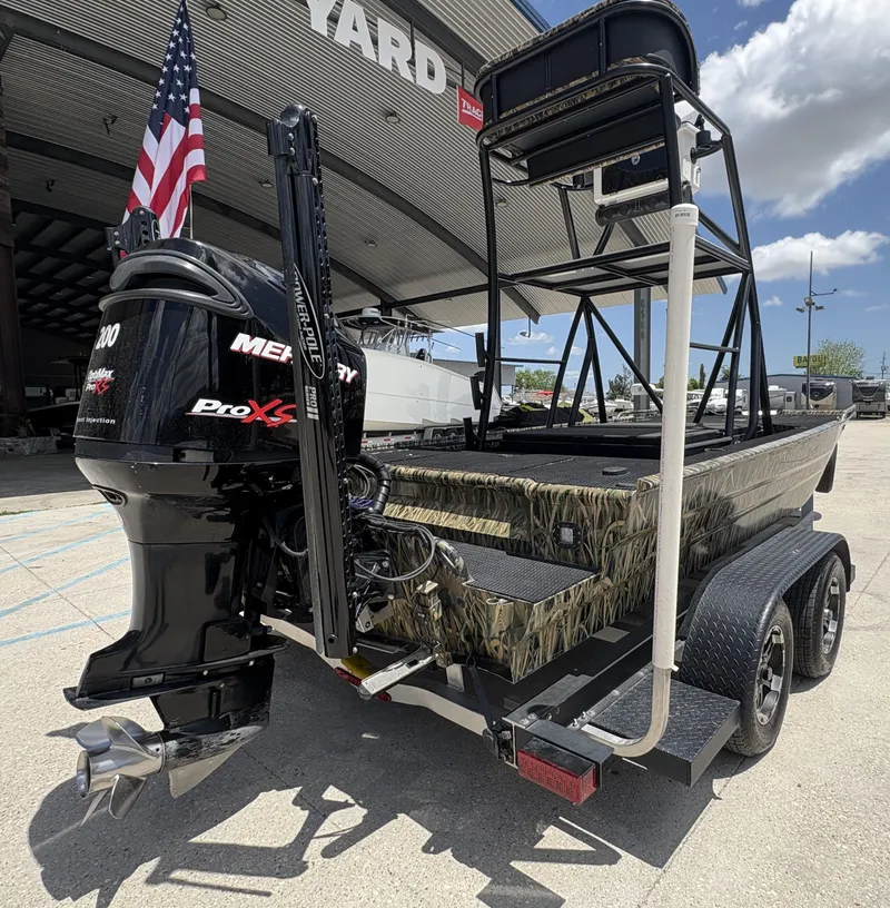 Slide: The Image of 2017 Prodigy 20 x 72 boat with Mercury Pro XS engine, parked outside a yard. - 5