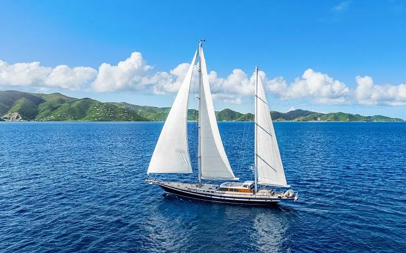 The Image of Sailing yacht Jongert Ketch 2002 on blue ocean with scenic island backdrop. - 0