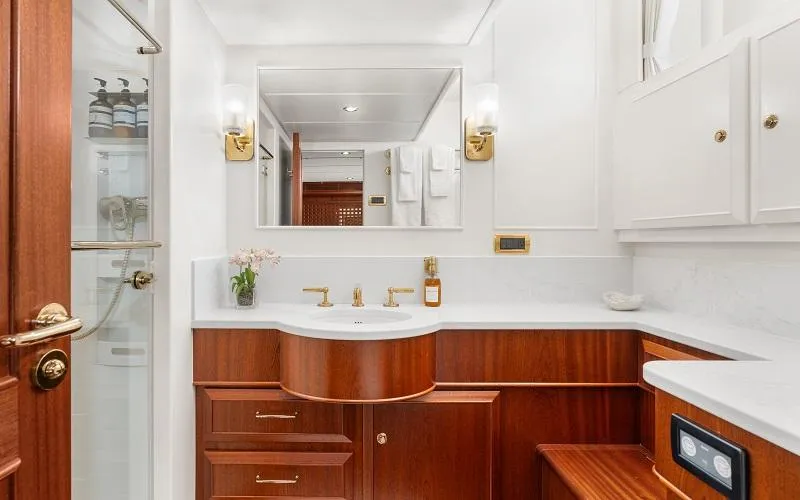 Slide: The Image of Luxurious yacht bathroom with wooden cabinetry, gold fixtures, and elegant lighting on a 2002 Jongert Ketch. - 17