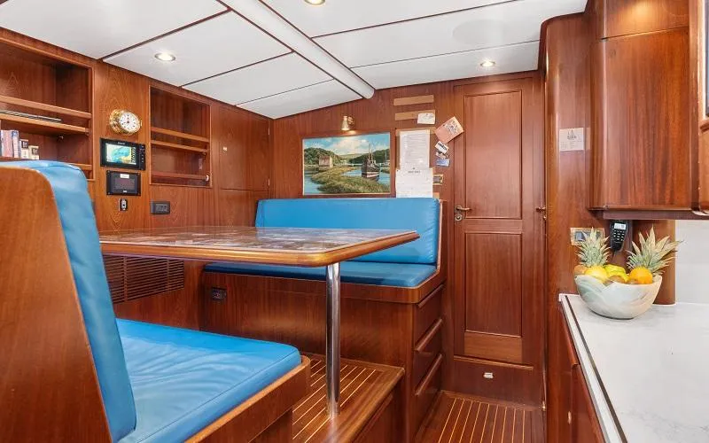 Slide: The Image of Luxurious 2002 Jongert Ketch yacht interior with wooden furnishings and blue seating. - 19