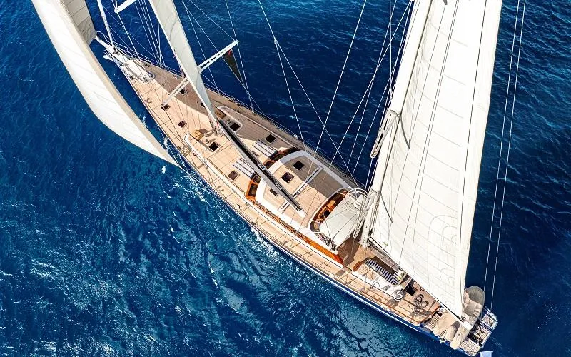 Slide: The Image of Aerial view of a 2002 Jongert Ketch sailing on blue ocean waters. - 24
