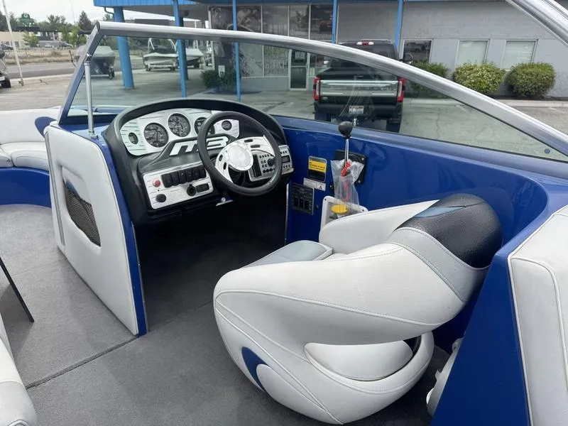 Slide: The Image of 2007 MB TOMCAT boat interior with steering wheel, dashboard, and captain's seat. - 12