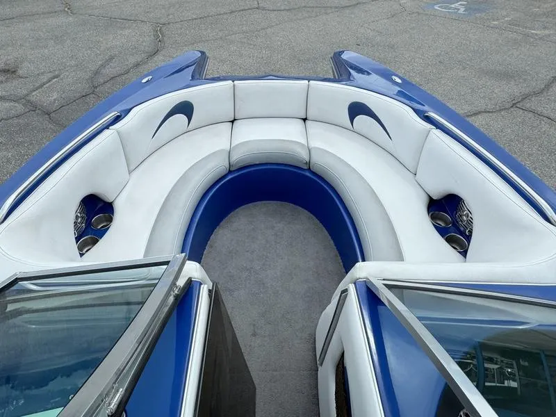 Slide: The Image of 2007 MB TOMCAT boat interior with blue and white seating and cup holders. - 2