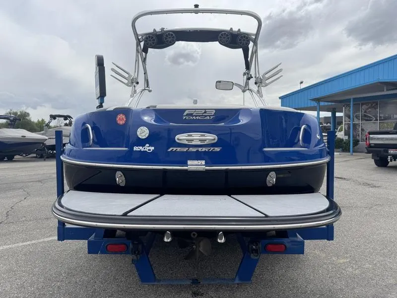 Slide: The Image of Blue 2007 MB TOMCAT boat with wakeboard tower, parked outdoors. - 7