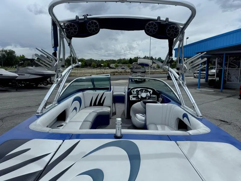 Slide: The Image of 2007 MB TOMCAT boat with custom interior and wakeboard tower, parked outdoors. - 8