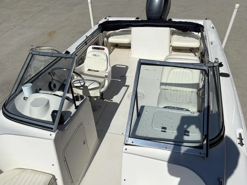 Slide: The Image of 2007 Sea Hunt Escape 200 boat interior with white seating and steering console. - 8