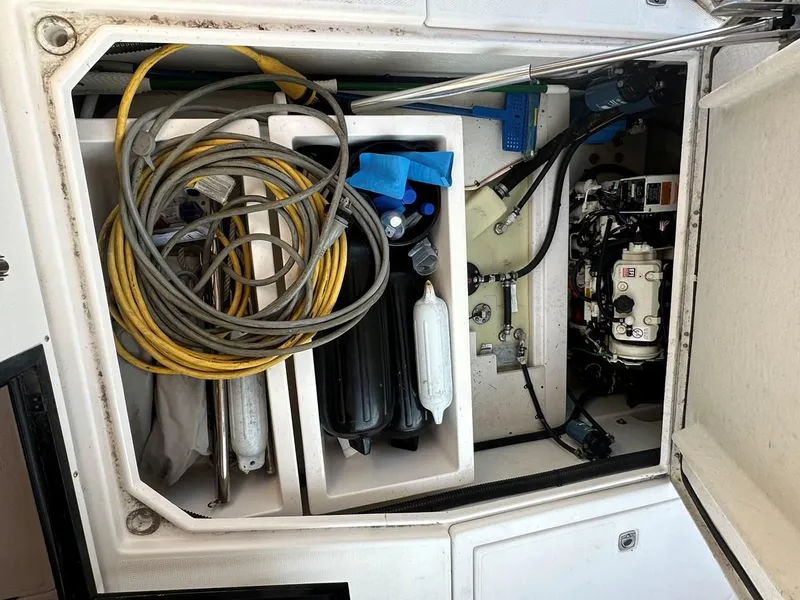 Slide: The Image of 2020 Cutwater C-32 CB storage compartment with cables, fenders, and mechanical components. - 11