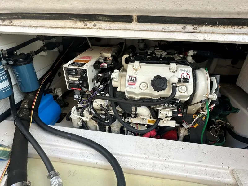 Slide: The Image of Engine compartment of a 2020 Cutwater C-32 CB boat, showcasing mechanical components and wiring. - 12