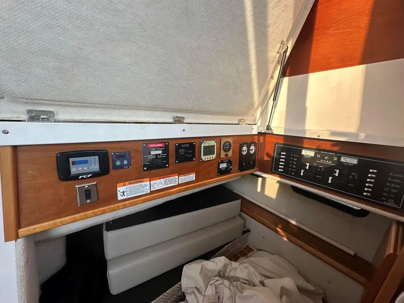 Slide: The Image of 2020 Cutwater C-32 CB control panel with various switches and gauges in cabin interior. - 13