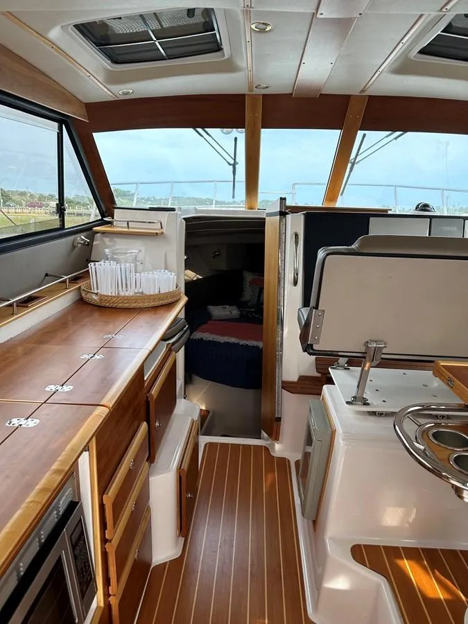 Slide: The Image of 2020 Cutwater C-32 CB interior with wood accents and modern amenities. - 14