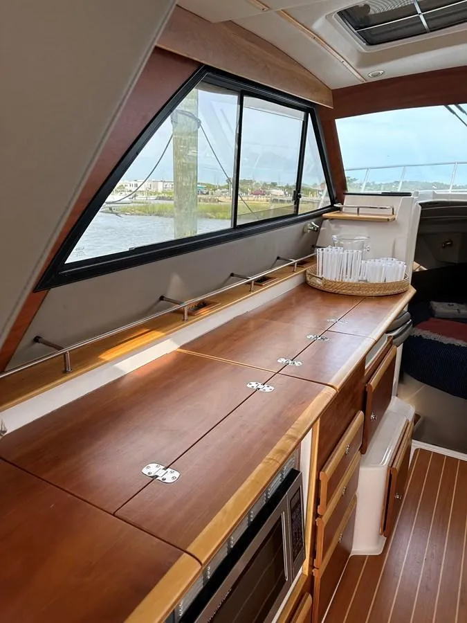 Slide: The Image of Interior of 2020 Cutwater C-32 CB yacht with wooden cabinetry and large windows. - 15
