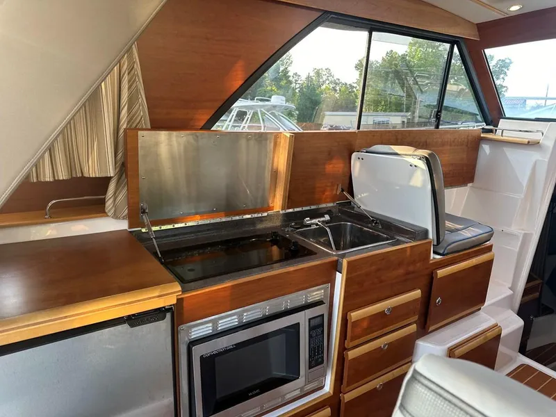 Slide: The Image of Interior of 2020 Cutwater C-32 CB boat featuring kitchen with microwave and sink. - 16