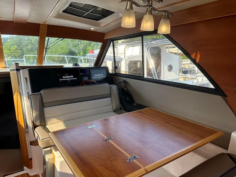 Slide: The Image of Interior of 2020 Cutwater C-32 CB boat with dining area and large windows. - 18