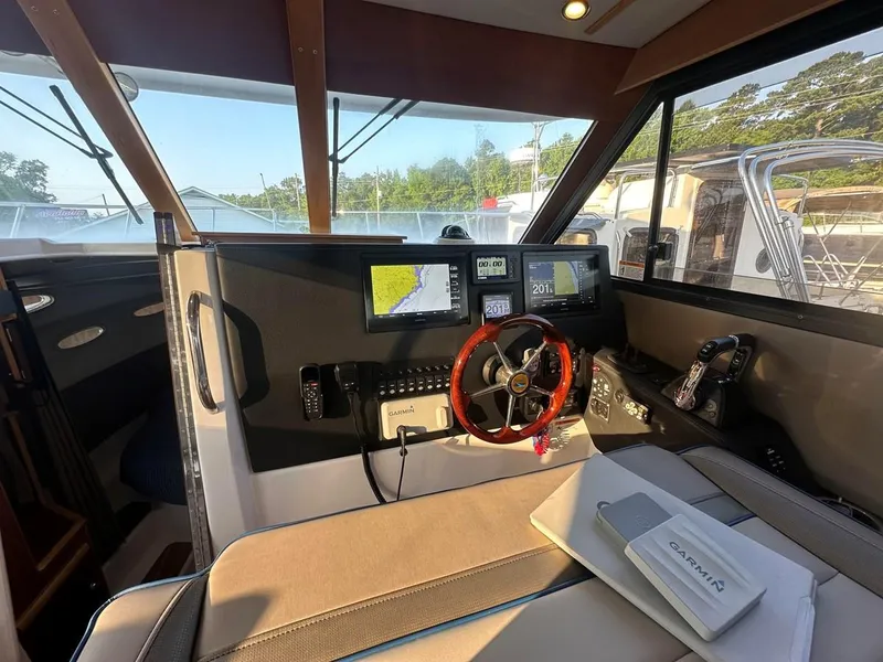 Slide: The Image of 2020 Cutwater C-32 CB boat cockpit with navigation screens and steering wheel. - 21