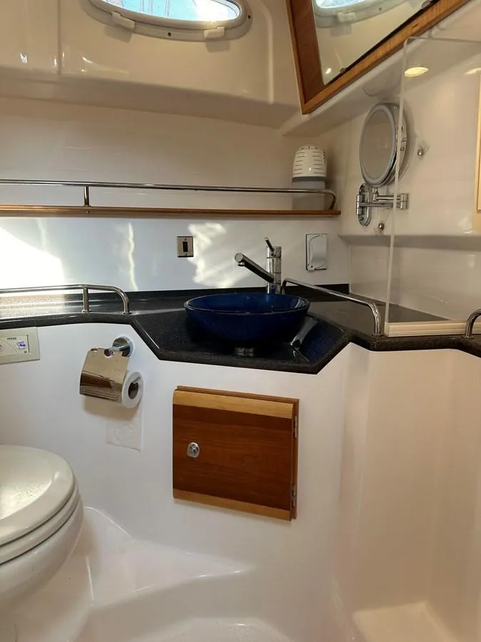Slide: The Image of 2020 Cutwater C-32 CB boat bathroom with sink, toilet, and mirror. - 23