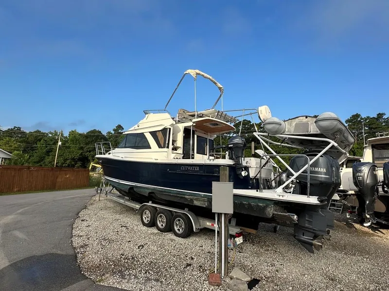 Slide: The Image of 2020 Cutwater C-32 CB boat on trailer, parked outdoors under clear sky. - 5