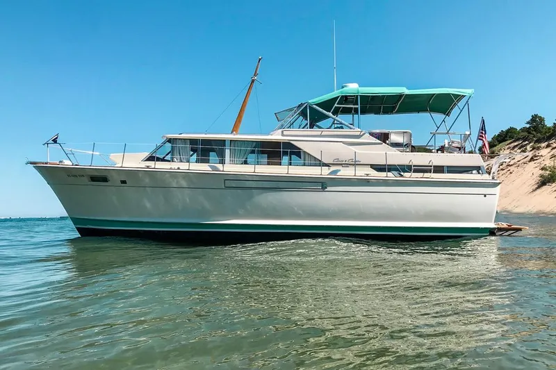The Image of 1967 Chris-Craft 42' Commander yacht on calm water, clear sky background. - 1