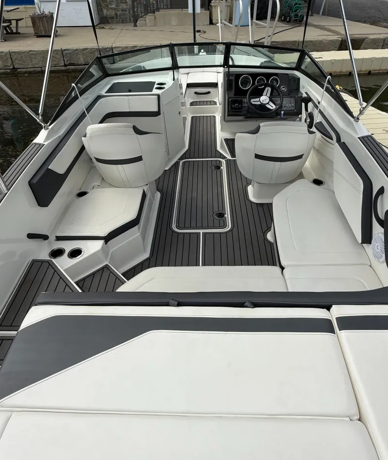 Slide: The Image of 2018 Sea Ray SPX 210 boat interior with white seating and sleek dashboard design. - 5