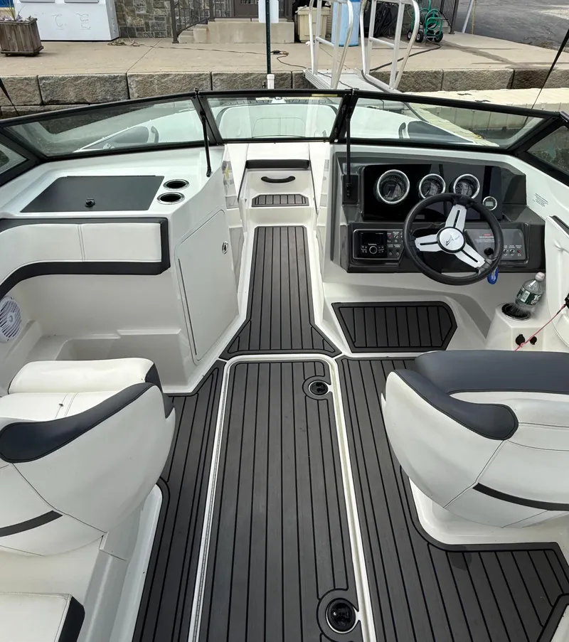 Slide: The Image of 2018 Sea Ray SPX 210 boat interior with sleek black and white design, modern dashboard, and seating. - 6