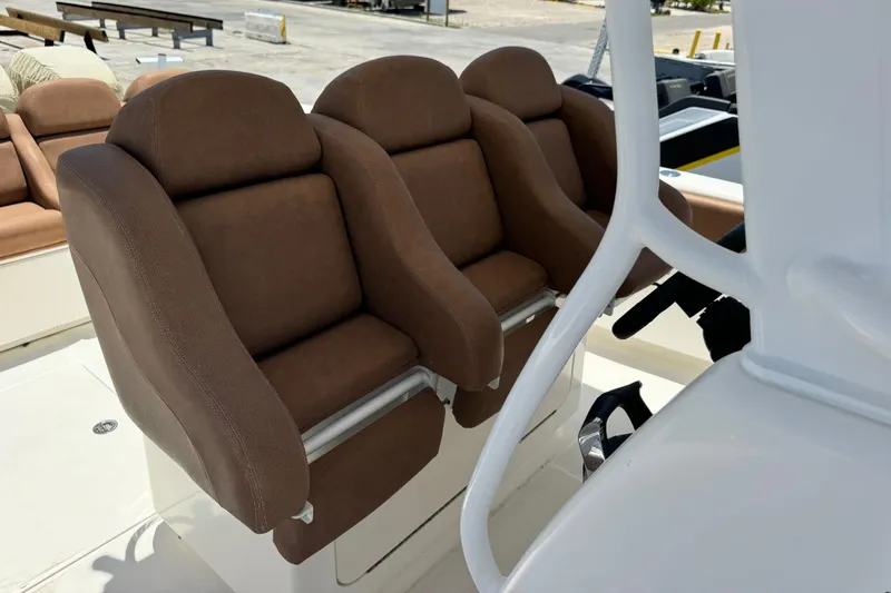 Slide: The Image of Brown cushioned seats on a 2010 Deep Impact 36 DI boat. - 10