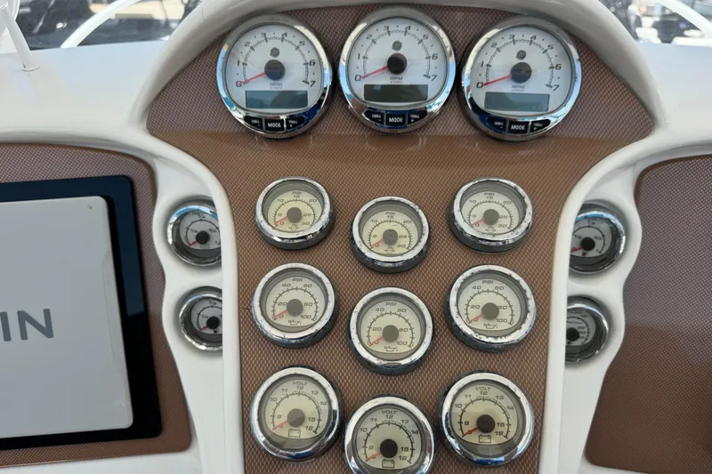 Slide: The Image of Dashboard of a 2010 Deep Impact 36 DI boat with multiple gauges and controls. - 12