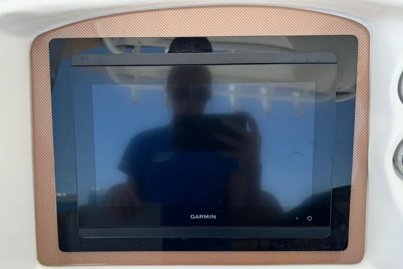 Slide: The Image of Garmin display on 2010 Deep Impact 36 DI boat dashboard, reflecting a person taking a photo. - 13