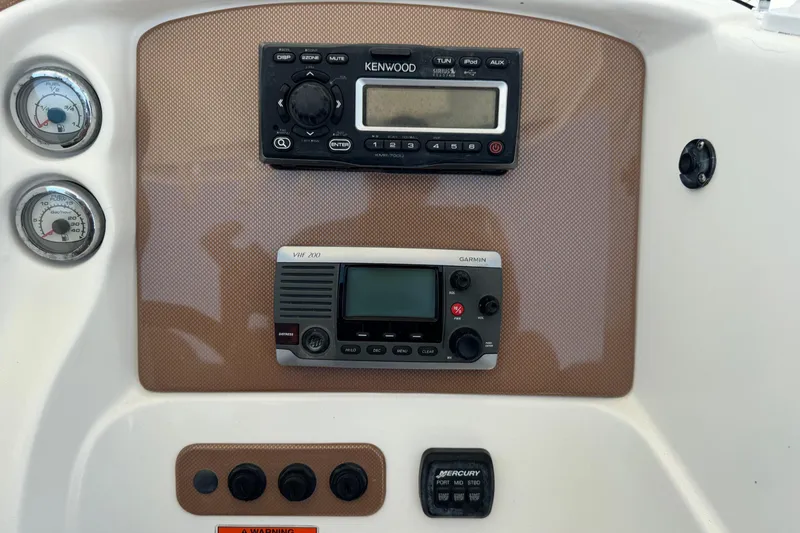 Slide: The Image of Control panel of a 2010 Deep Impact 36 DI boat with Kenwood radio and gauges. - 16