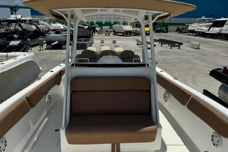 Slide: The Image of 2010 Deep Impact 36 DI boat with brown seating, docked in a marina. - 17