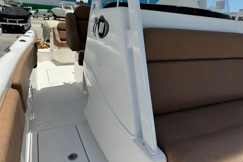 Slide: The Image of 2010 Deep Impact 36 DI boat interior with brown seating and white deck. - 18