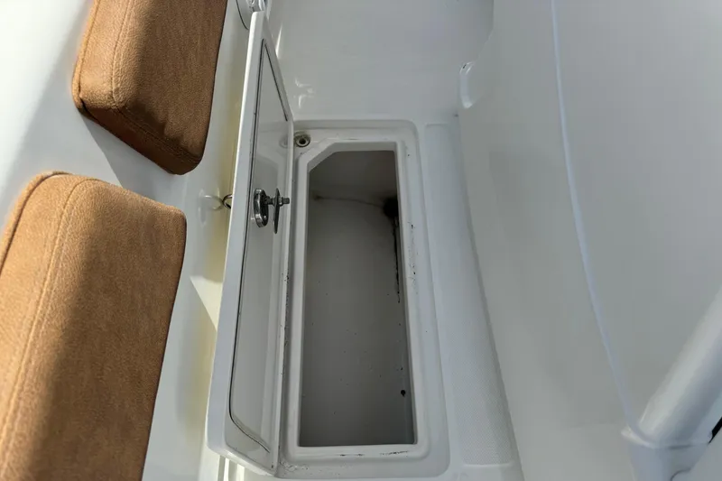 Slide: The Image of Storage compartment on a 2010 Deep Impact 36 DI boat with brown cushions. - 19