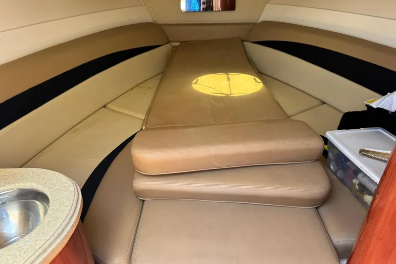 Slide: The Image of Interior cabin of 2010 Deep Impact 36 DI boat with beige seating and compact amenities. - 26