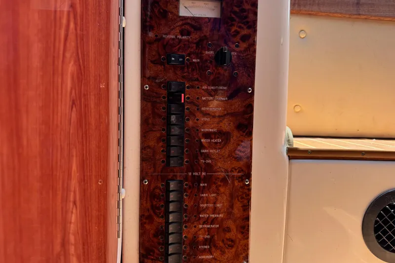 Slide: The Image of Control panel of a 2010 Deep Impact 36 DI boat, featuring switches and indicators. - 31